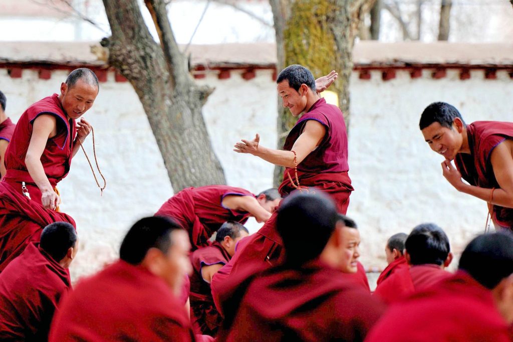 The monks were debating in the courtyard of Sera Monastery during cultural tour with Easy Tibet Tours, a tibetan tour company